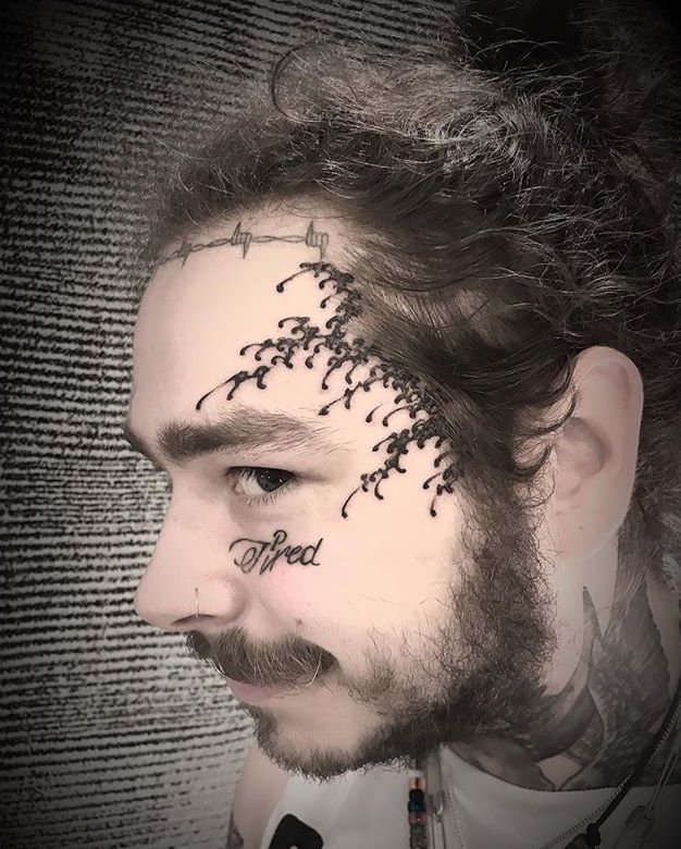 Malone Gets Fresh Face Tattoo While Visiting Japan